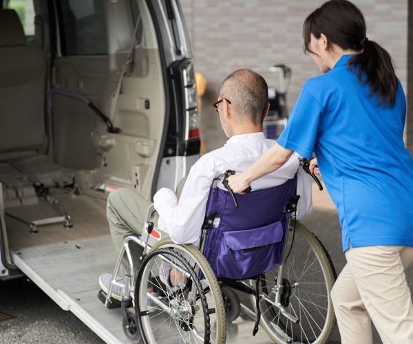 A caregiver who puts an elderly person in a long-term care taxi